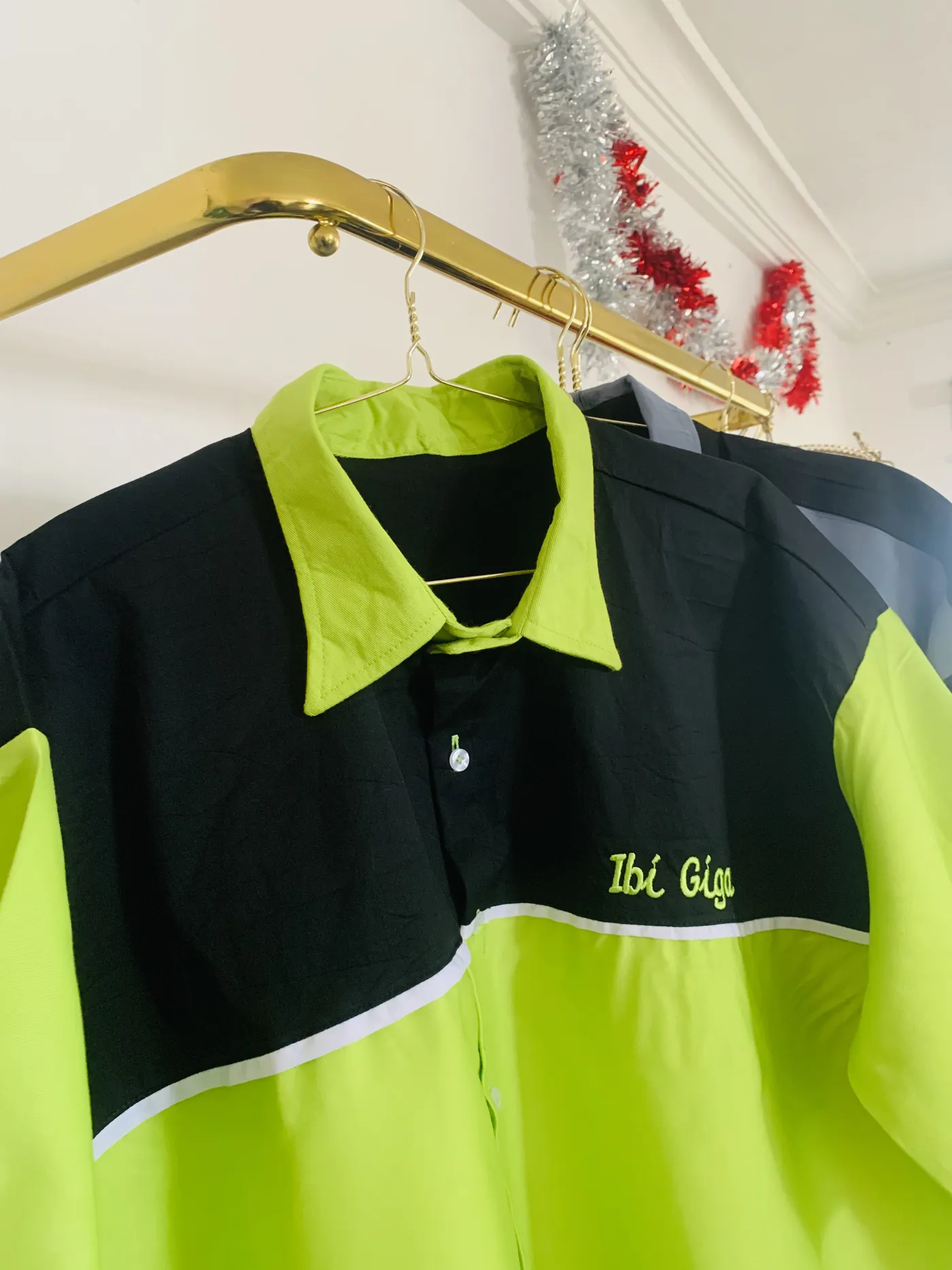Black and bright green branded uniform shirt