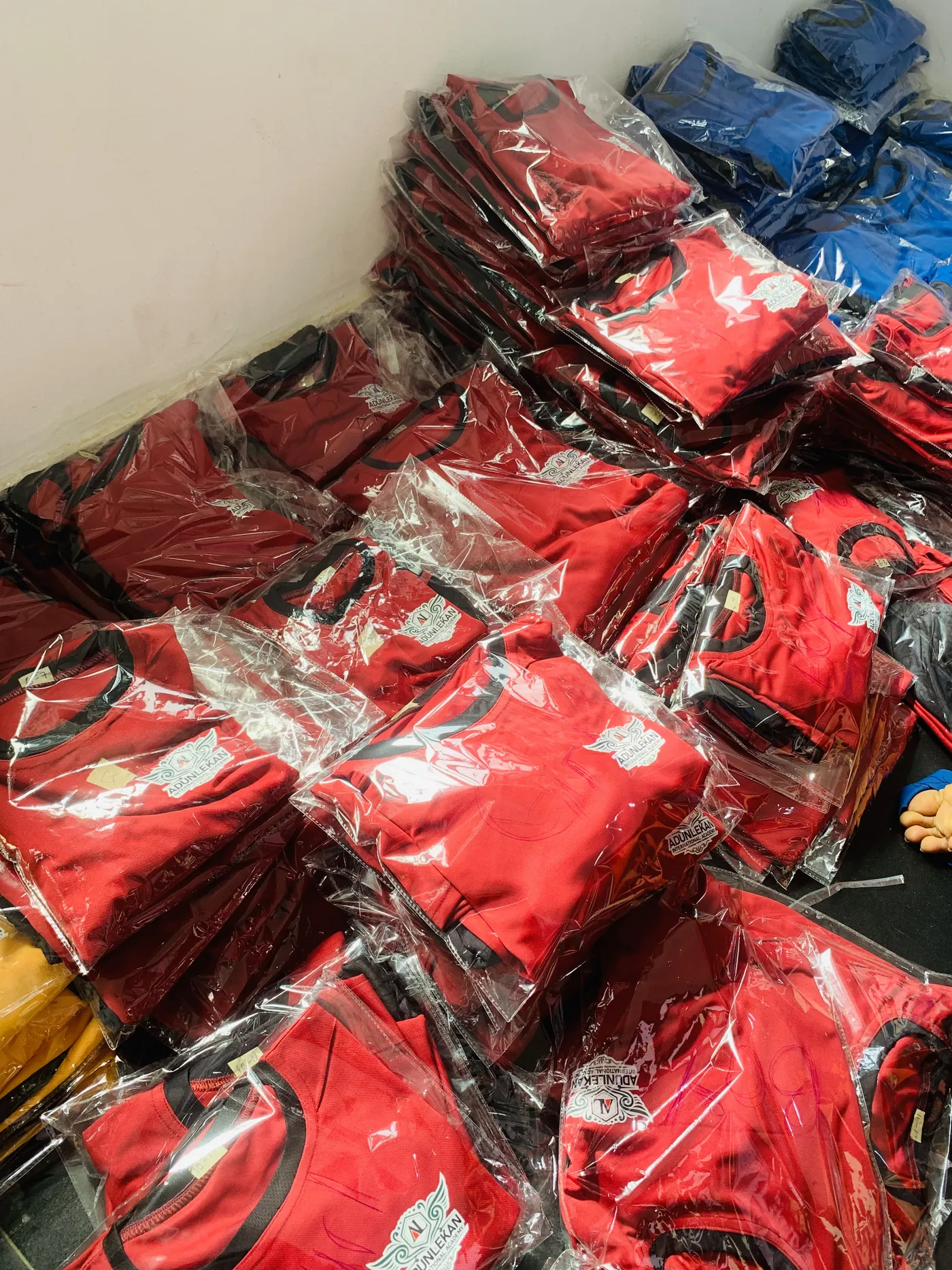 Packaged red branded garments prepared in batches