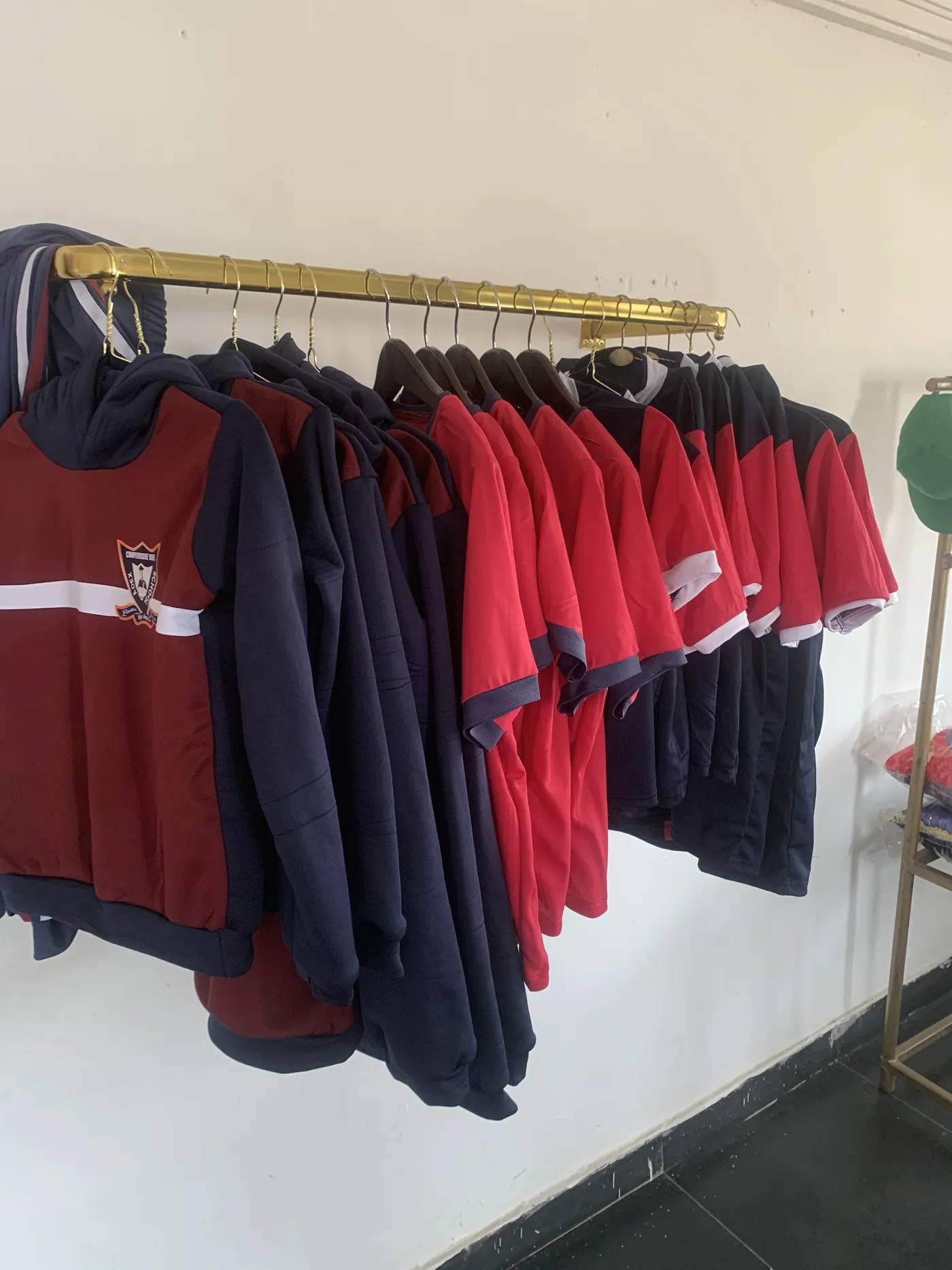 Finished school sportswear arranged on a rail