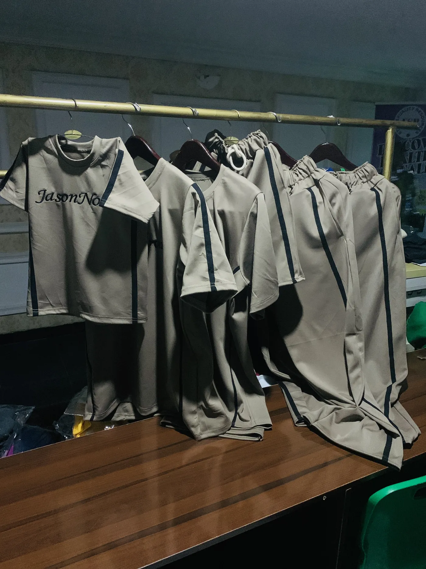 Completed grey uniform sets arranged on a rail